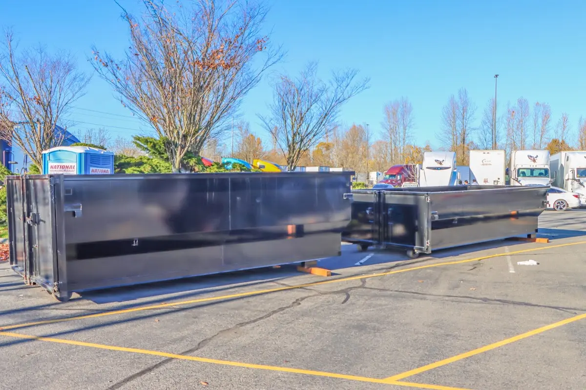 Professional dumpster rental service with roll-off container on residential driveway in Austin